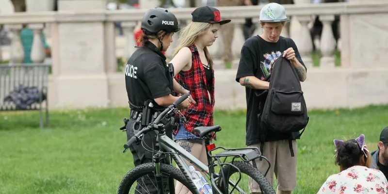 Image: A pair of Denver 420 Rally attendees interacting with police.