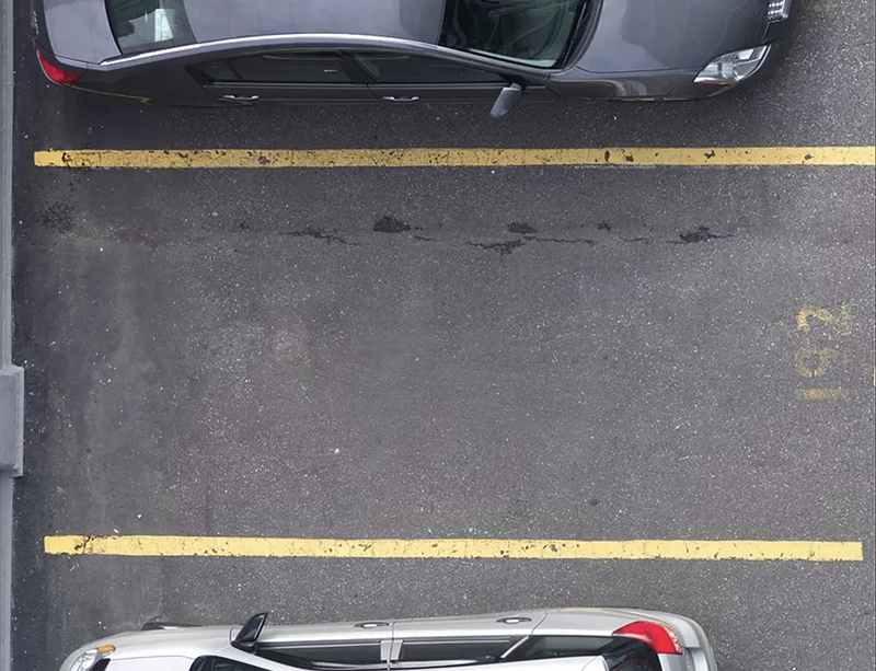 Image: empty parking spot between two parked cars
