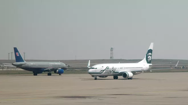 grounded united airlines and alaskan airlines planes on runway