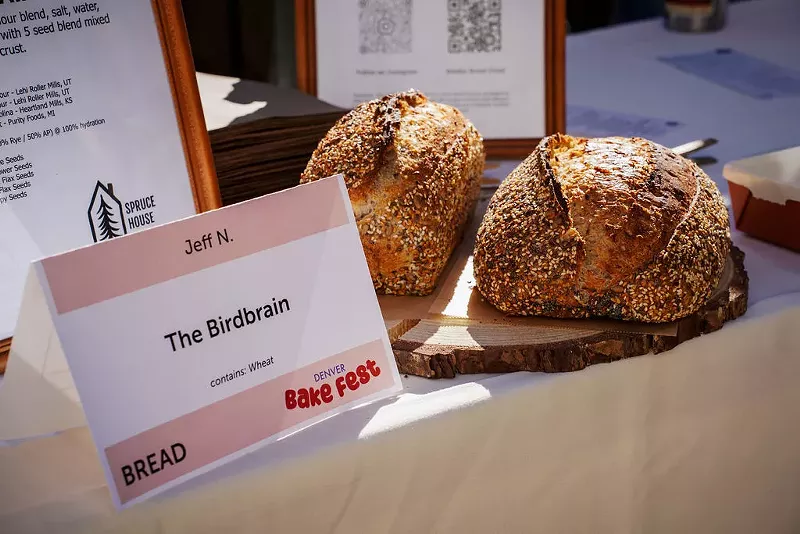 Image: Two loaves of bread next to a sign reading "The Birdbrain,"