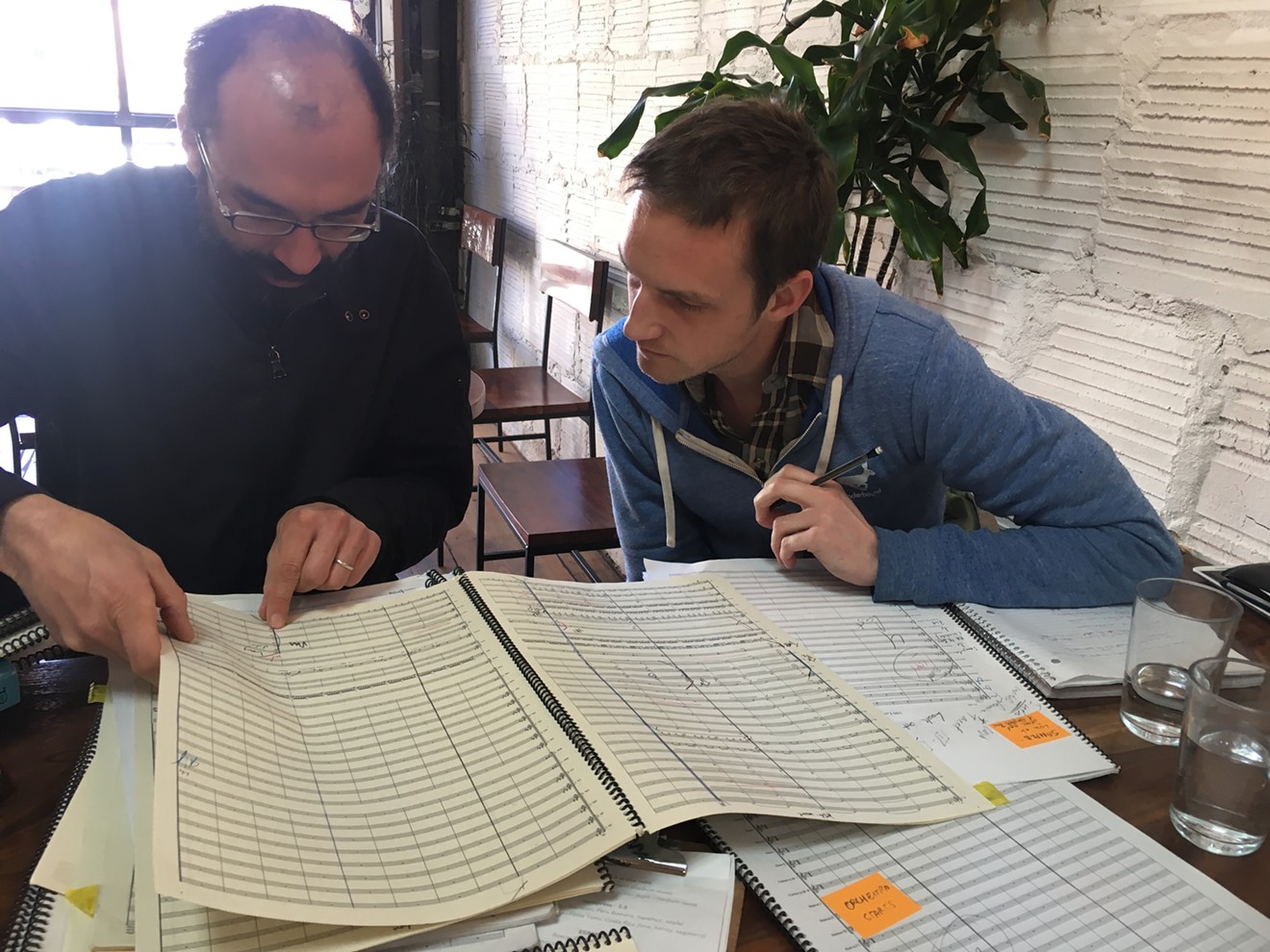 Tom Hagerman (left) reviews Chimney Choir's composition with bandmember David Rynhart ahead of Wonderbound's production of Mayhem.