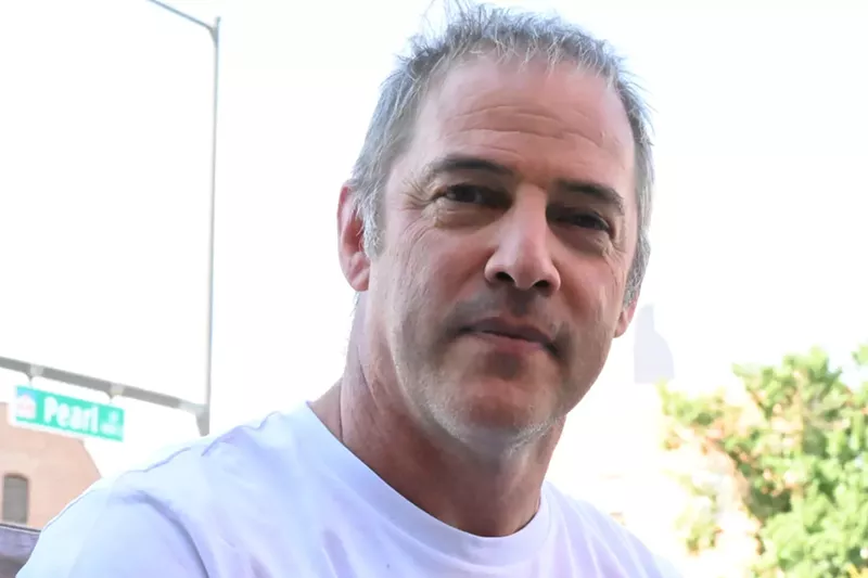 Image: A man looks at the camera.