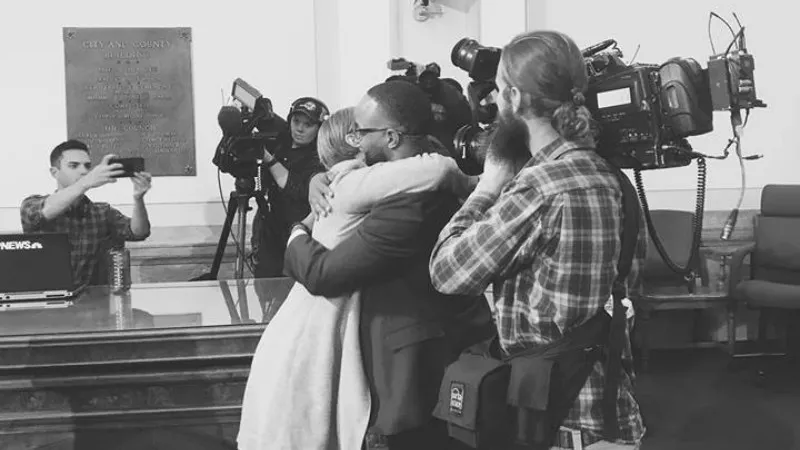 Image: Denver City Council member Albus Brooks embraces Harm Reduction Action Center executive director Lisa Raville.