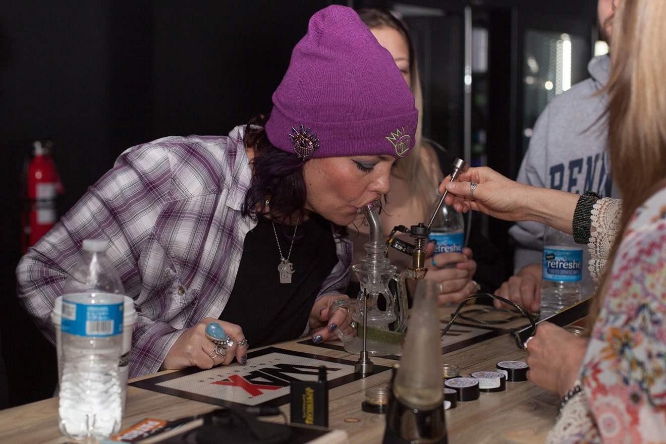 A woman takes a dab at Dean Ween's Honey Pot Lounge, one of two licensed social pot consumption businesses in Denver.