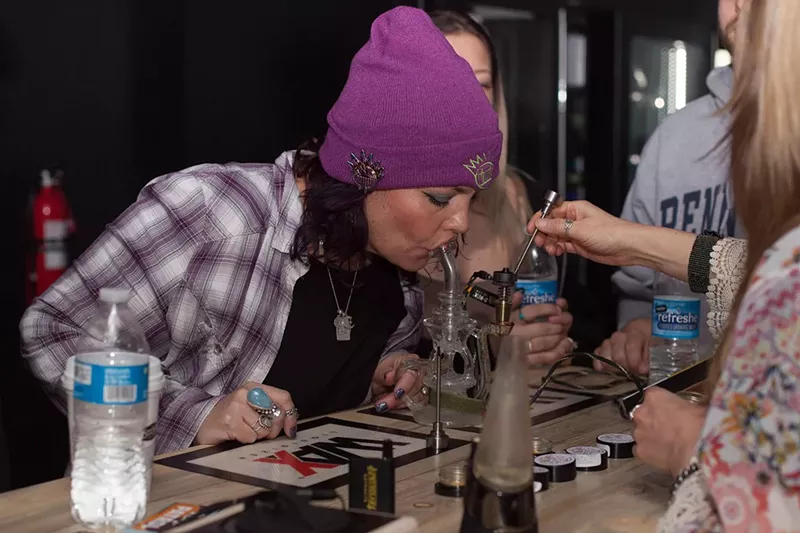 Image: A woman takes a dab at Dean Ween's Honey Pot Lounge, one of two licensed social pot consumption businesses in Denver.
