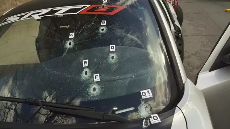 Image: The bullet-hole-peppered windshield of Dion Damon's Dodge Charger.