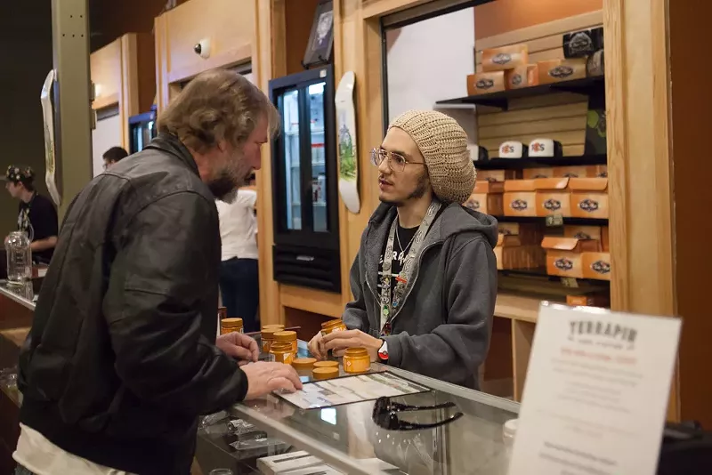 Image: A Terrapin Care Station dispensary budtender helps a customer.