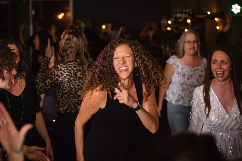 Image: Women dance together.
