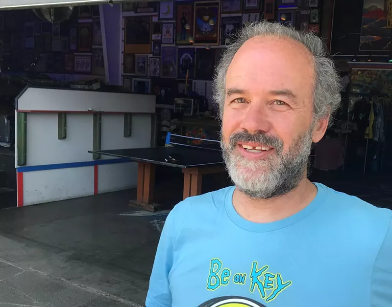Image: Man in blue shirt on porch