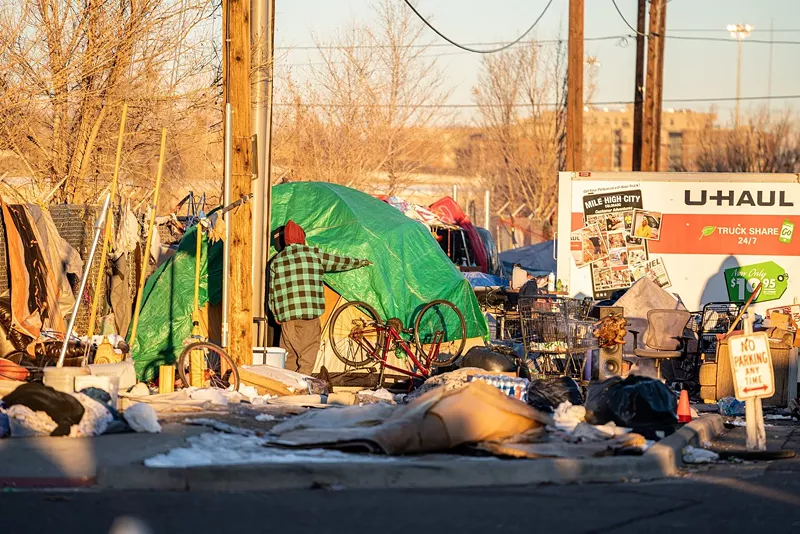 Image: Residents of a homeless encampment packing up prior to a November 2020 sweep by City of Denver employees.