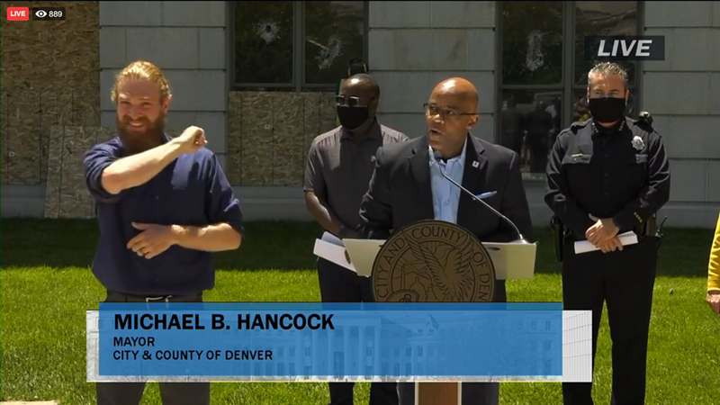 Image: Michael Hancock delivered his remarks in front of a damaged City and County Building.
