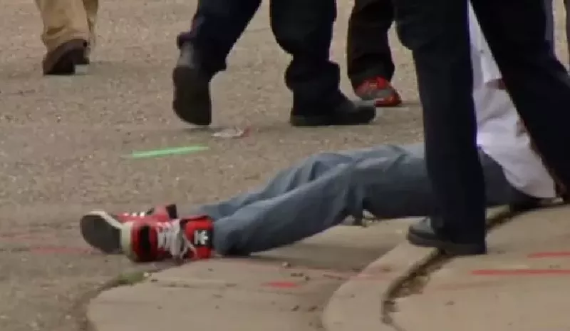 Image: A suspect being taken into custody after a May 2015 shooting investigated by the Aurora gang unit.