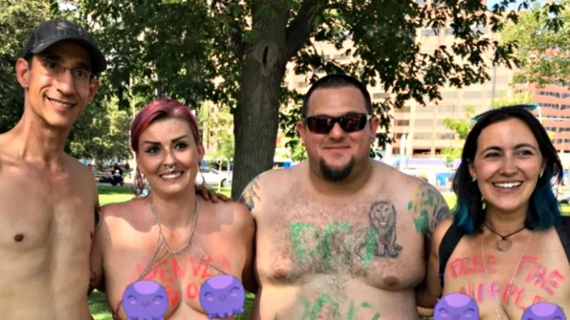 Image: Matt Wilson and Mia Jean, left, join other participants at Denver Go Topless Day 2017.