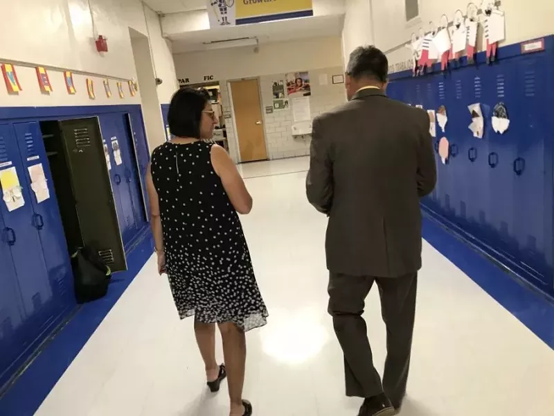 Image: Former interim Denver superintendent Ron Cabrera, right, walks down a hallway with Stedman Elementary Principal Greta Martinez in September 2018.