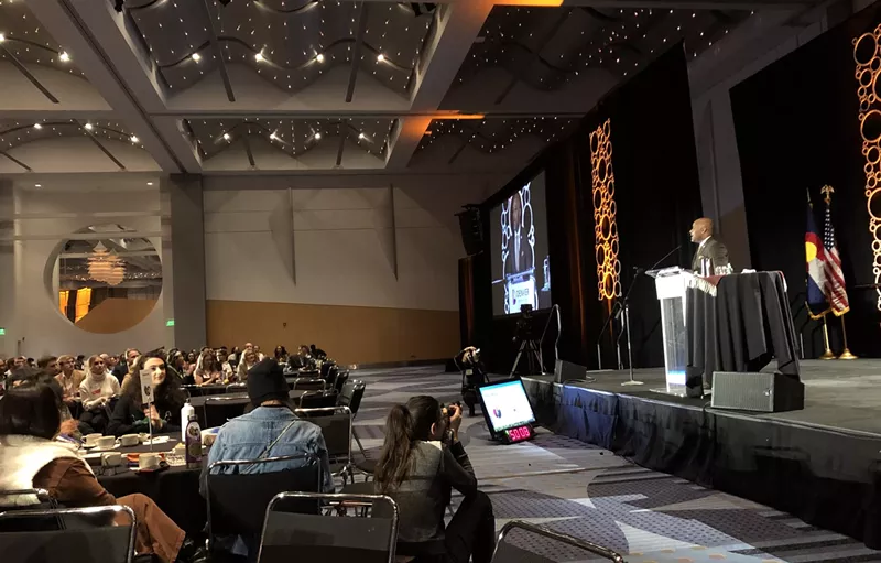 Image: Mayor Michael Hancock addresses the fifth annual Sustainable Denver Summit as youth climate activists look on.