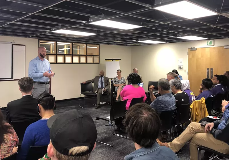Image: Councilman Jolon Clark, Mayor Michael Hancock and other city officials met with Denver residents on October 2 to discuss a proposal to raise the city's minimum wage.