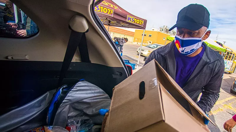 Image: Denver Mayor Michael Hancock taking part in a food drive last month.