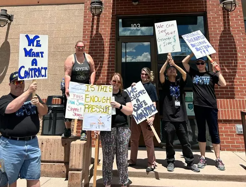 Image: Unionized Elements Massage employees protest their employer's union busting tactics on May 27.