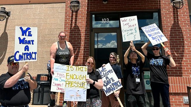 Unionized Elements Massage employees protest their employer's union busting tactics on May 27.