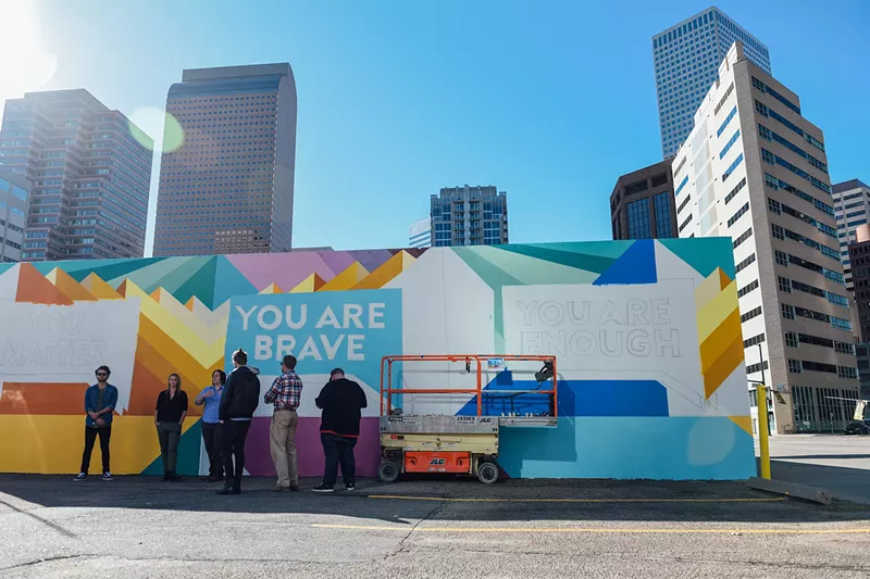 Image: Members of the Find Your Words campaign, Tennyson Center for Children and Kaiser Permanente Colorado stand in front of their half-completed mural on Thursday, October 12.