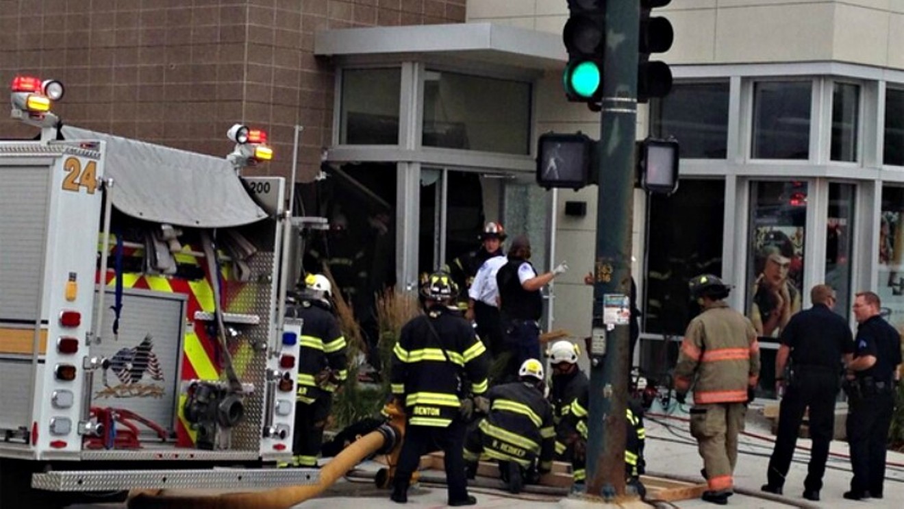 A photo from a July 2014 accident involving an SUV that crashed into a building. One woman died in the incident.