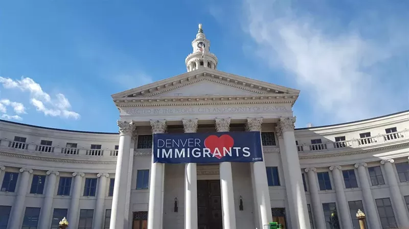 Image: Denver's City and County Building with a banner showing love to immigrants.