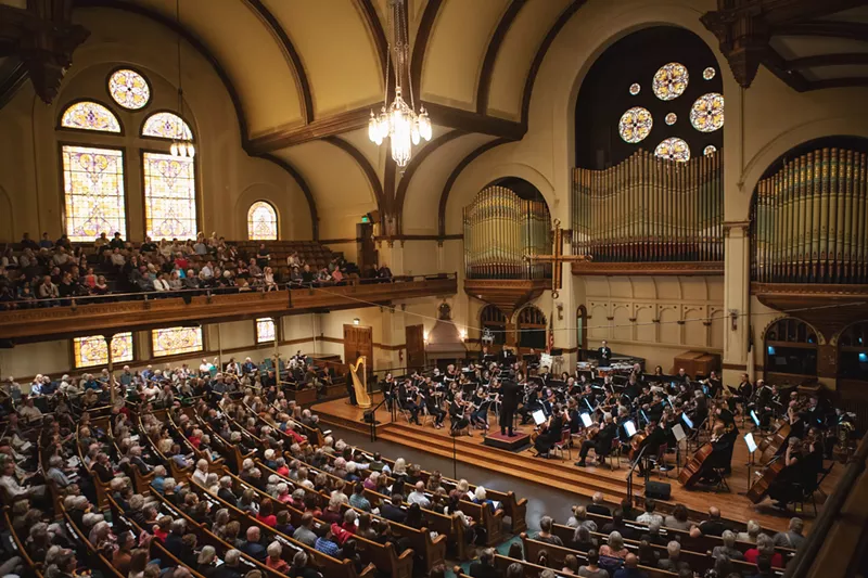 Image: People watch an orchestra play