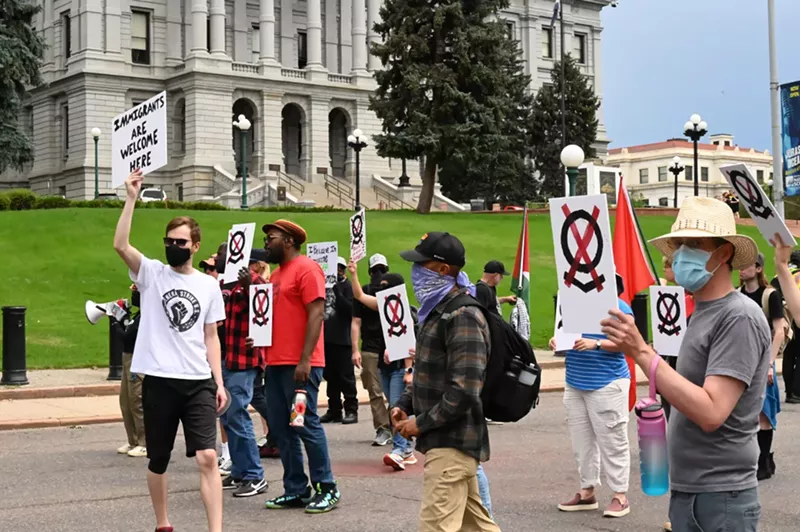 Image: A small group of protesters march.