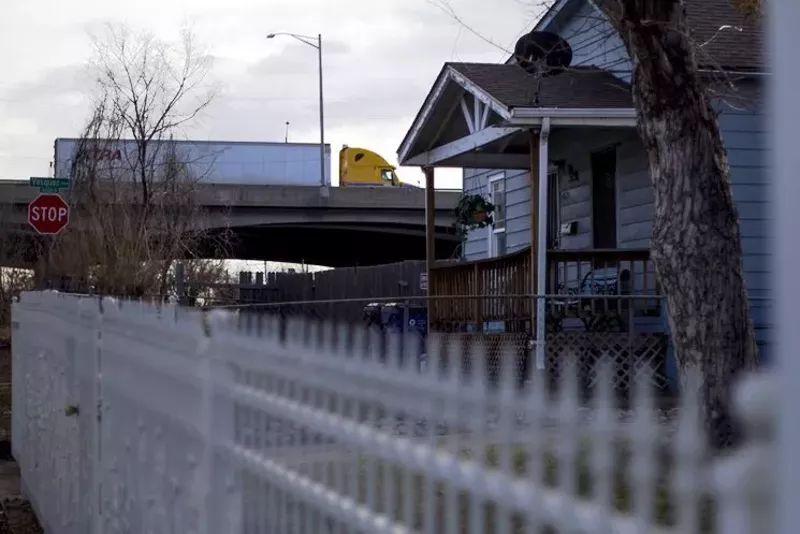 Image: A truck rumbles along the I-70 viaduct above a house in Elyria.