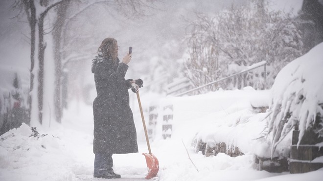 Woman takes photo of snow in Denver while shoveling her sidewalk