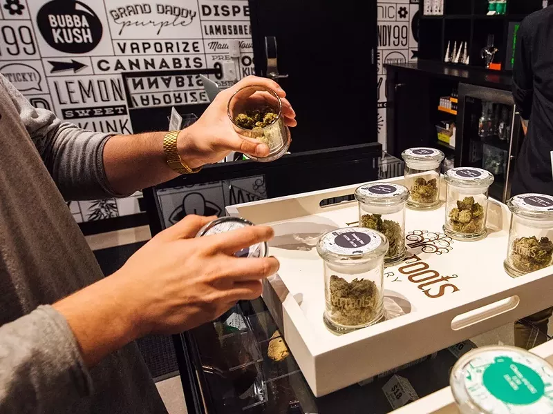 Image: A dispensary customer shops for cannabis flower