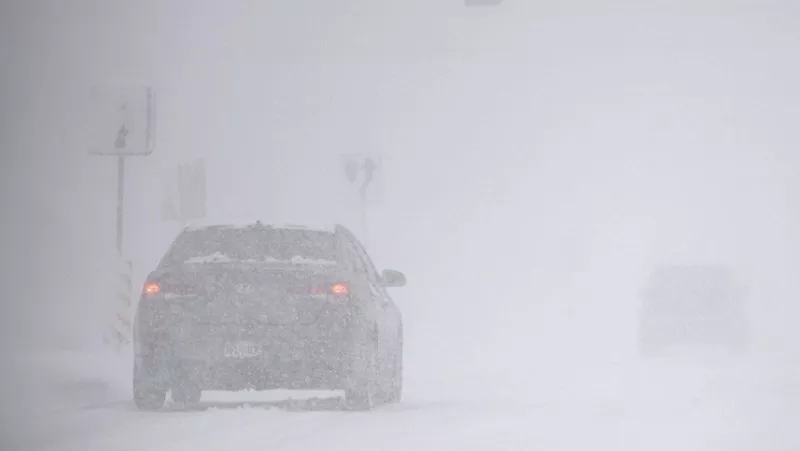 Image: Car drives through snowstorm