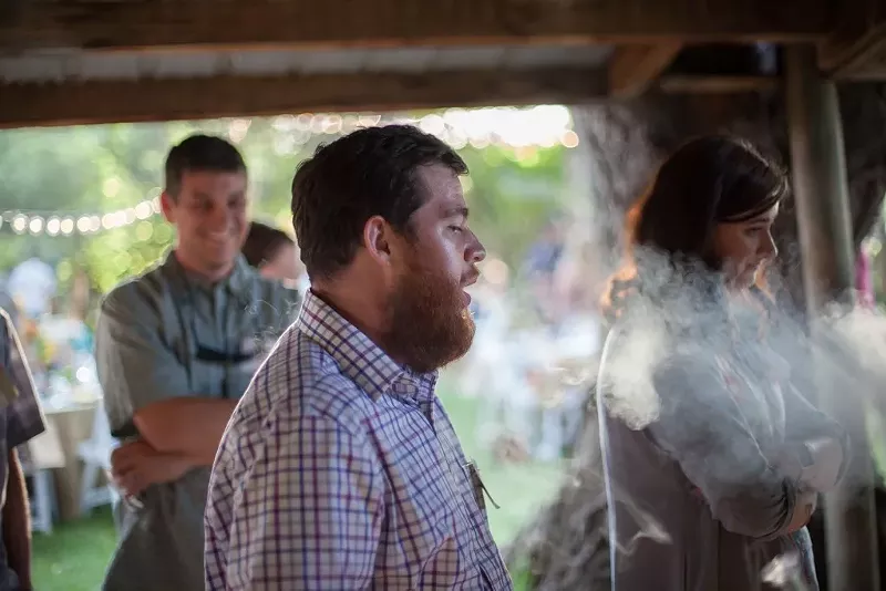 Image: Patrons of a private cannabis consumption event in Longmont wait for a free dab.