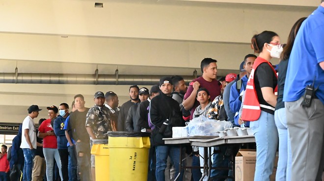A line of mostly Venezuelan migrants waiting in line for food at the 5th Street Garage on Denver's Auraria Campus.
