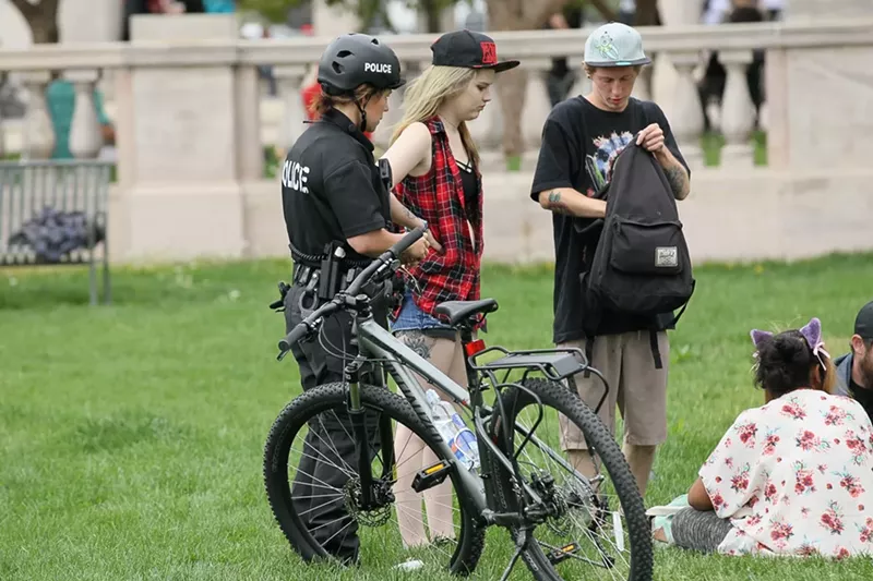 Image: A Denver Police Department officer confronts attendees at the 420 Rally at Civic Center Park in 2016.