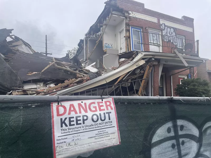 Image: Destroyed house with warning signs
