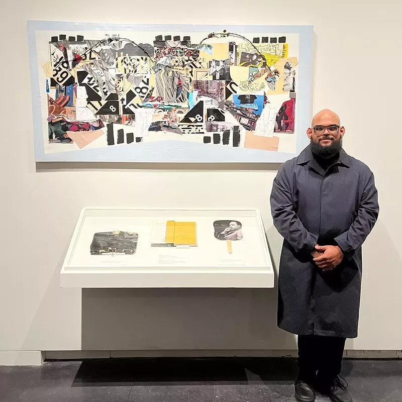 Image: man standing next to his artwork