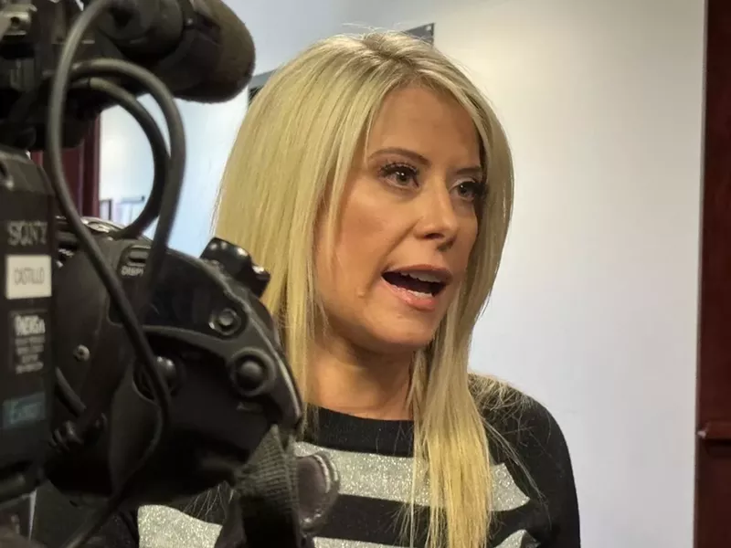 Image: A woman talks to the media.