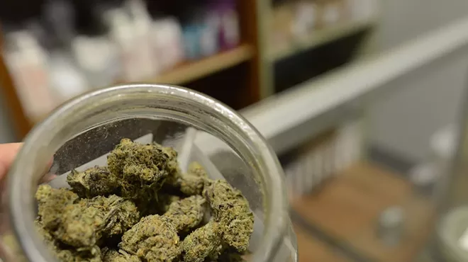 Open jar of cannabis buds
