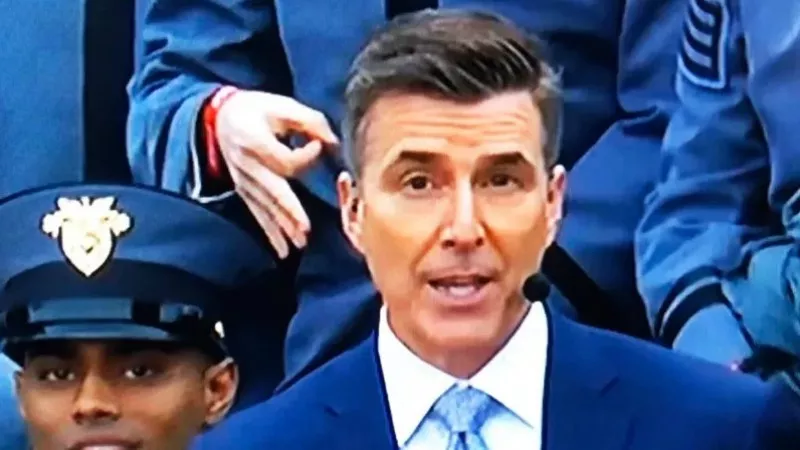 Image: A member of the military offers a hand gesture associated with the white-power movement behind ESPN broadcaster Rece Davis during this weekend's Army-Navy game.