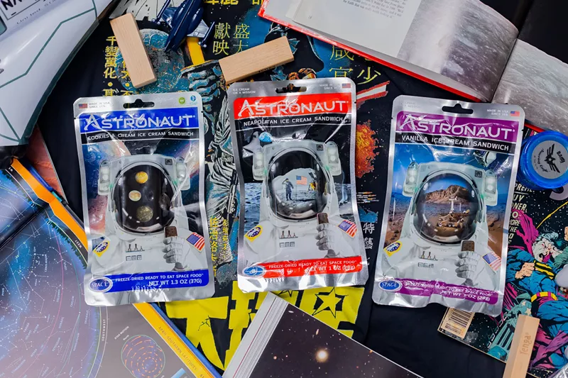 Image: Three Astronaut Foods ice cream sandwich packages backdropped by comic books