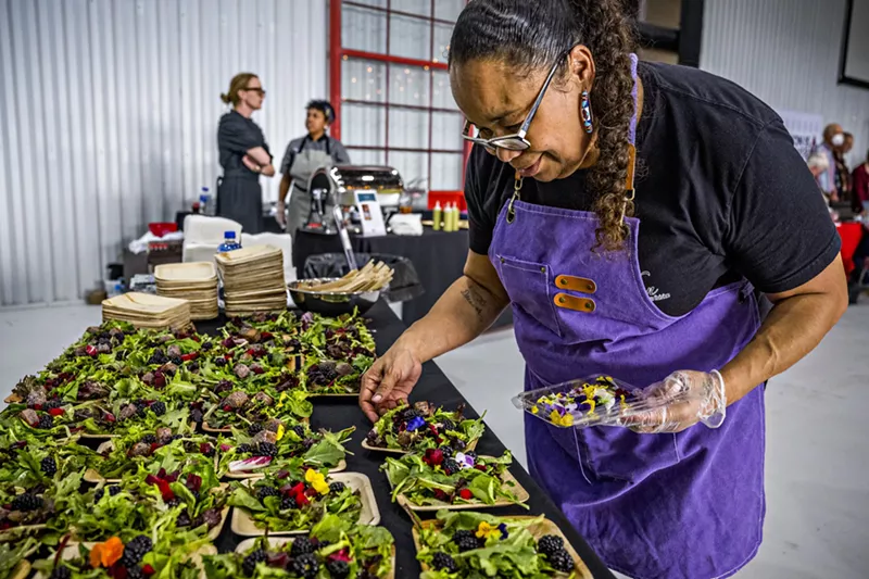 Image: A chef plating multiple salad dishes at Denver EATSS