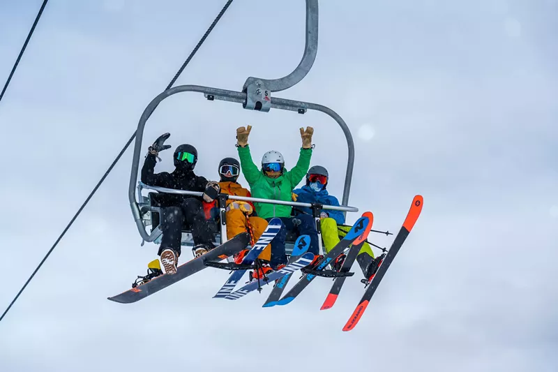 Image: Four skiers on a Breckenridge Ski Resort chair lift