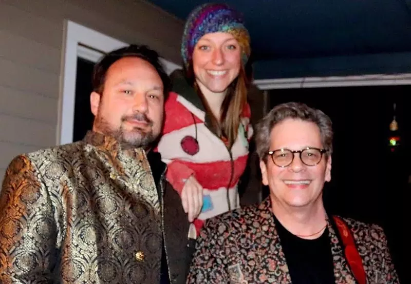 Image: two men and a woman smile for the camera