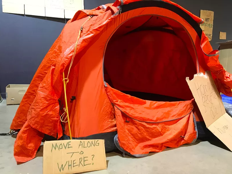 Image: Friday's event at RedLine included an exhibit of signs and tents used by those experiencing homelessness.