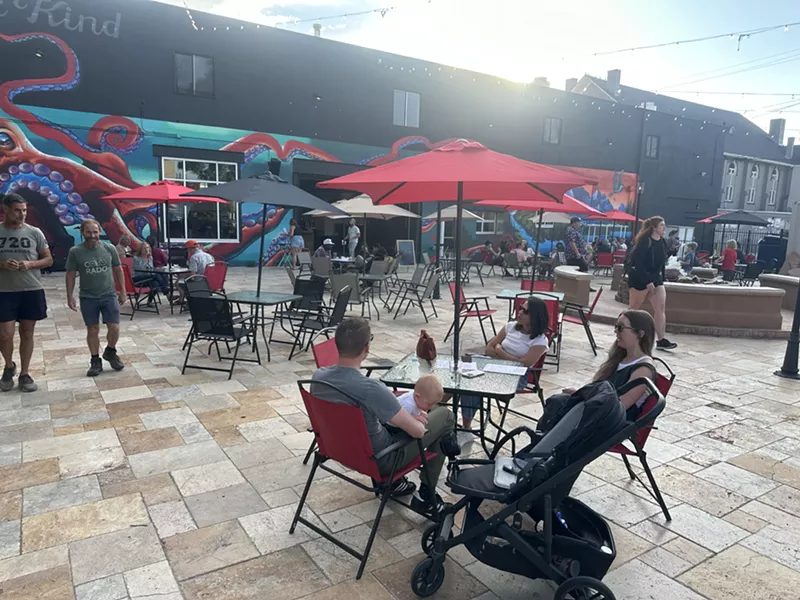 Image: people sitting at tables on a patio