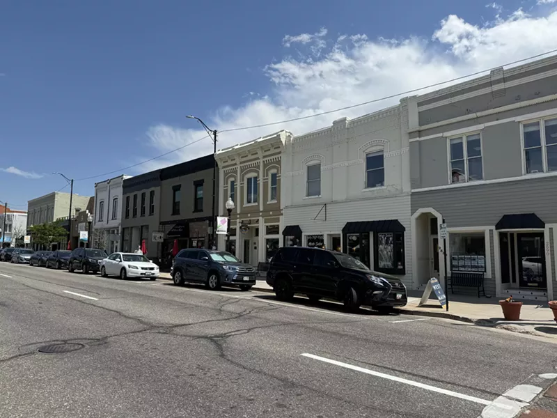Image: Buildings along a street with cars parked in front