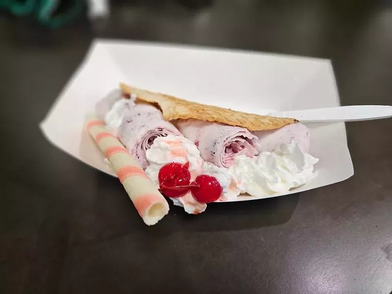 Image: house-made waffle, strawberry ice cream, and whipped cream.