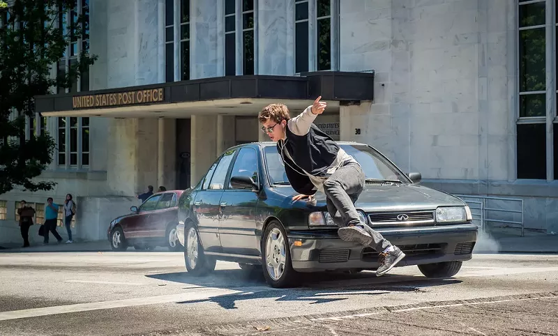 Image: Ansel Elgort dancing with a car.