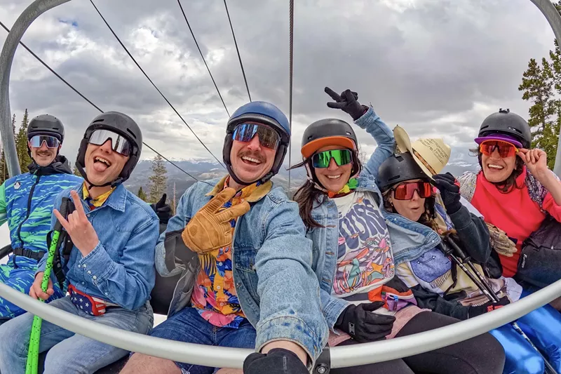 Image: A group of six skiers in spring attire on a Breckenridge Ski Resort lift